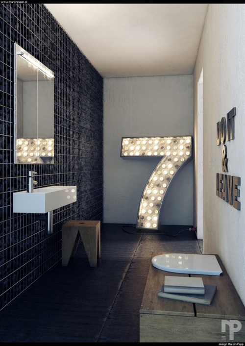 minimalistyczna czarna łazienka z dodatkiem w postaci dużej świecącej siódemki daje nietuzinkowe połączenie