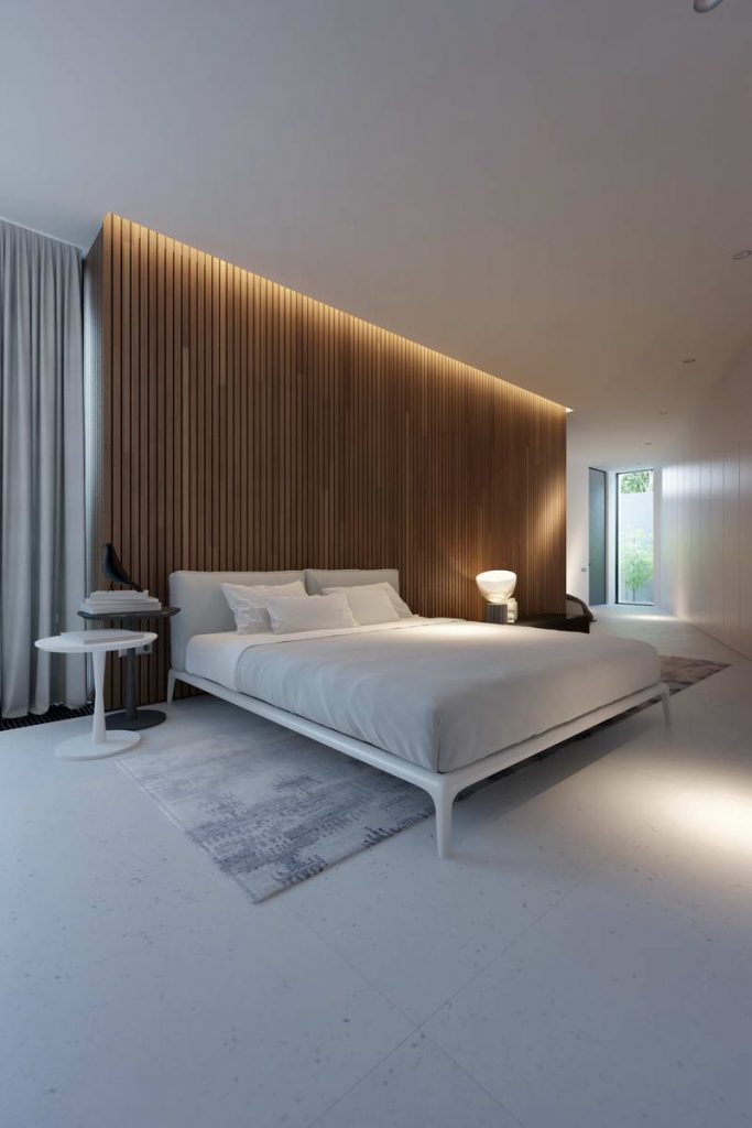 minimalna sypialnia z łożem na tle drewnianych paneli podświetlonych ledami.